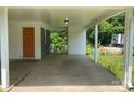 Large carport featuring a concrete floor, neutral paint, and offers access to the side yard at 2322 Hedgewood Cir, Gastonia, NC 28052