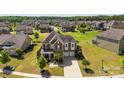 Aerial view of the house with a well-maintained lawn in a community of homes at 2511 Carnation Dr, Harrisburg, NC 28075