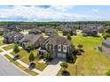 Aerial view of the house with a well-maintained lawn in a community with lush green spaces at 2511 Carnation Dr, Harrisburg, NC 28075