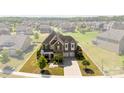Aerial view of the house with a well-maintained lawn in a community of homes at 2511 Carnation Dr, Harrisburg, NC 28075