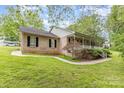 Brick home with a well-maintained lawn, walkway, and inviting front porch at 302 6Th Sw St, Conover, NC 28613