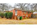 Brick house with an access stairs, some trash cans, and utilities visible on the back at 3232 Marlborough Rd, Charlotte, NC 28208