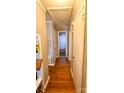 Inviting hallway featuring gleaming hardwood floors, neutral paint, and classic trim at 3232 Marlborough Rd, Charlotte, NC 28208