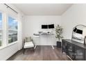Bright home office with a modern adjustable desk, dual monitors, and stylish decor at 3618 Catherine Creek Pl, Davidson, NC 28036