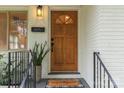 Close-up of a front door featuring a solid wood door, modern hardware, and stylish decor at 4021 Paisley Pl, Charlotte, NC 28208