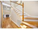 Bright foyer featuring hardwood floors, a staircase with white spindles, and fireplace view at 4790 Cascade Ave, Rock Hill, SC 29732