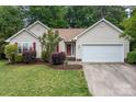 Charming one-story home boasts manicured lawn, fresh landscaping, and a two-car garage at 508 Long Creek Pkwy, Charlotte, NC 28214