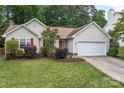 Charming one-story home boasts manicured lawn, fresh landscaping, and a two-car garage at 508 Long Creek Pkwy, Charlotte, NC 28214