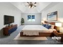 Inviting main bedroom with tray ceiling, king bed, and stylish modern furnishings at 628 Highland Ridge Rd, Mooresville, NC 28115