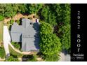Aerial view of home with mature trees and lush greenery, showing a 2022 roof installation at 6729 Garden Hill Dr, Huntersville, NC 28078