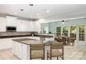 Bright kitchen featuring white cabinets, granite countertops, stainless appliances and a cozy dining nook at 6729 Garden Hill Dr, Huntersville, NC 28078