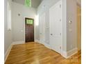 Bright foyer with hardwood floors, high ceilings, and a stylish wooden front door at 7324 Leharne Dr, Charlotte, NC 28270