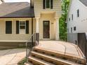 Inviting front entrance with stone steps, metal railings, and a sheltered porch with columns at 7324 Leharne Dr, Charlotte, NC 28270