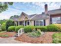 Inviting home with lush landscaping, complemented by colorful flowers and a well-maintained yard at 9232 Four Mile Creek Rd, Charlotte, NC 28277