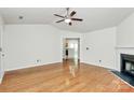 Open-concept living room boasting hardwood floors and a view into the kitchen at 9232 Four Mile Creek Rd, Charlotte, NC 28277