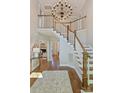 Grand foyer with high ceilings, chandelier, staircase, and hardwood floors with decorative rug at 9526 Greyson Ridge Dr, Charlotte, NC 28277