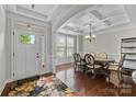 Elegant dining room featuring a coffered ceiling, hardwood floors, and ample natural light at 1004 Craven St, Indian Trail, NC 28079