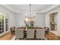Bright dining room features modern chandelier, neutral colors, and adjacent wine storage at 1009 Seminole Dr, Waxhaw, NC 28173