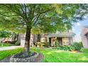 Charming two-story home with manicured lawn, stone exterior, and inviting front porch at 10115 Paxton Run Rd, Charlotte, NC 28277