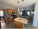 Well-lit kitchen with a center island, oak cabinets and stainless steel appliances at 12244 Wallace Ridge Dr, Charlotte, NC 28269