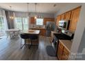 Bright eat-in kitchen featuring a center island, stainless appliances, and wood cabinets at 12244 Wallace Ridge Dr, Charlotte, NC 28269