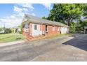 Single-story brick home with a welcoming front door, a spacious driveway and an inviting, comfortable appeal at 124 10Th Sw St, Conover, NC 28613
