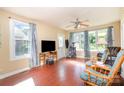 The open living room has wood floors, ceiling fan, large windows, and a cat tower at 124 10Th Sw St, Conover, NC 28613