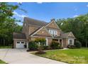 Beautiful brick home with a manicured lawn, attached garage, and a welcoming driveway at 1410 Smoketree Ct, Waxhaw, NC 28173