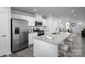 Modern kitchen boasts white cabinets, stainless steel appliances, and granite countertops at 153 Jameson Park Dr # 4, Troutman, NC 28166