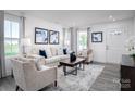 Comfortable living room with neutral furniture, modern artwork, and lots of natural light at 153 Jameson Park Dr # 4, Troutman, NC 28166