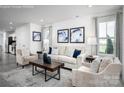 Bright living room with large windows, neutral furnishings, and stylish decor at 153 Jameson Park Dr # 4, Troutman, NC 28166
