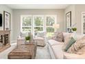 Bright living room with large windows offering backyard views, comfortable seating, and stylish decor at 2008 Waxhaw Crossing Dr, Waxhaw, NC 28205