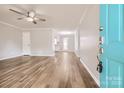 Bright, open-concept living room featuring hardwood floors, ceiling fan, and modern decor at 201-A Ewing Dr, Belmont, NC 28012