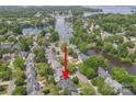 Stunning aerial view of waterfront community with lush trees, near the lake and marina at 21203 Harken Dr, Cornelius, NC 28031