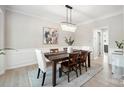Elegant dining room with chandelier, decorative wainscoting, and a sophisticated ambiance at 21203 Harken Dr, Cornelius, NC 28031