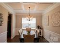 Formal dining room featuring wainscotting, a coffered ceiling, a chandelier and modern decor at 217 Hydrangea Dr, Clover, SC 29710