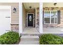 Inviting front porch featuring stone accents, classic columns, and a stylish front door at 217 Hydrangea Dr, Clover, SC 29710