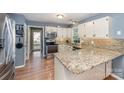 Bright kitchen featuring white cabinets, granite countertops, stainless steel appliances, and stylish backsplash at 2342 Castlecomer Dr, Charlotte, NC 28262