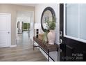 Inviting entryway featuring wood-look flooring, console table, and decorative mirror at 2635 Tillman St, Monroe, NC 28112