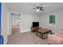 Cozy living room featuring wood-look floors, a modern ceiling fan, and a comfortable sitting area at 2729 S Ridge Ave, Concord, NC 28025