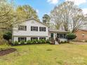 Inviting exterior featuring a well-manicured lawn and blooming trees, showcasing classic charm at 2816 Eastport Rd, Charlotte, NC 28205
