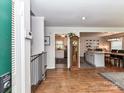 Inviting foyer showcases hardwood floors leading to a bright kitchen and cozy dining area at 2816 Eastport Rd, Charlotte, NC 28205