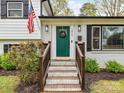 Welcoming entrance featuring a green door, brick steps, and classic address display at 2816 Eastport Rd, Charlotte, NC 28205
