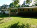 Inviting home exterior with a verdant lawn, brick facade, and a welcoming front porch at 2826 Drew Dr, Lancaster, SC 29720