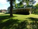 Cozy, single-Gathering home featuring a lush green lawn and mature trees providing ample shade at 2826 Drew Dr, Lancaster, SC 29720