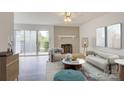 Cozy living room showcasing a brick fireplace, modern furniture and decor, and large sliding glass door at 2916 Iron Gate Ln, Charlotte, NC 28212