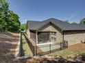Beautiful backyard with a screened patio, and a black metal fence at 3002 Portico Pl, Tega Cay, SC 29708