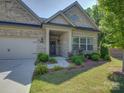 Charming home facade with a well-kept lawn and beautiful landscaping at 3002 Portico Pl, Tega Cay, SC 29708