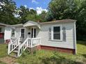 Charming single-story home with a cozy porch and well-maintained yard in a quiet neighborhood at 315 Broad Sw Dr, Concord, NC 28025
