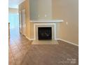 Comfortable living room highlighting a marble fireplace and tile flooring at 3527 Creeping Flora Ln, Charlotte, NC 28216